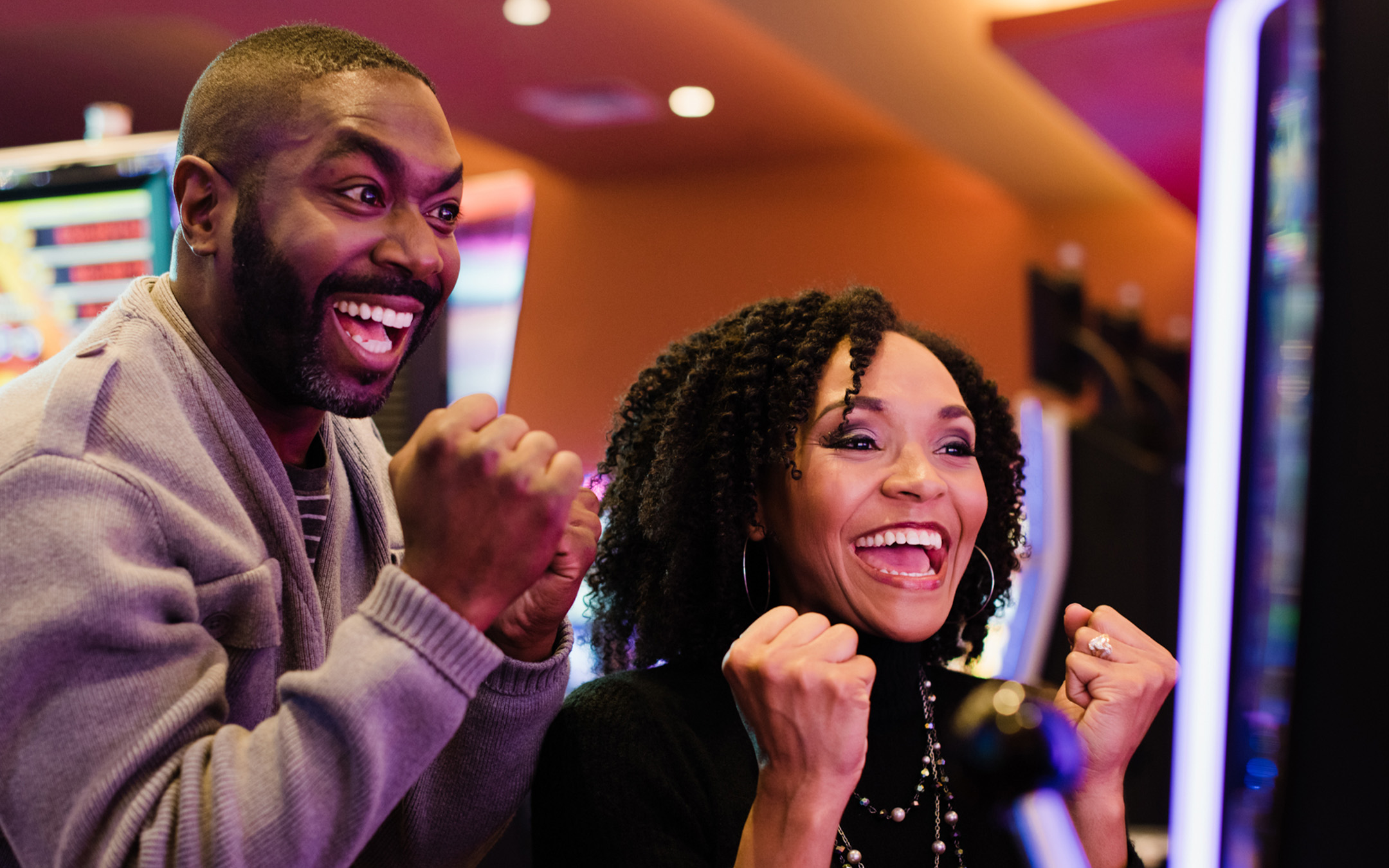 Two people celeberating a win in the casino.